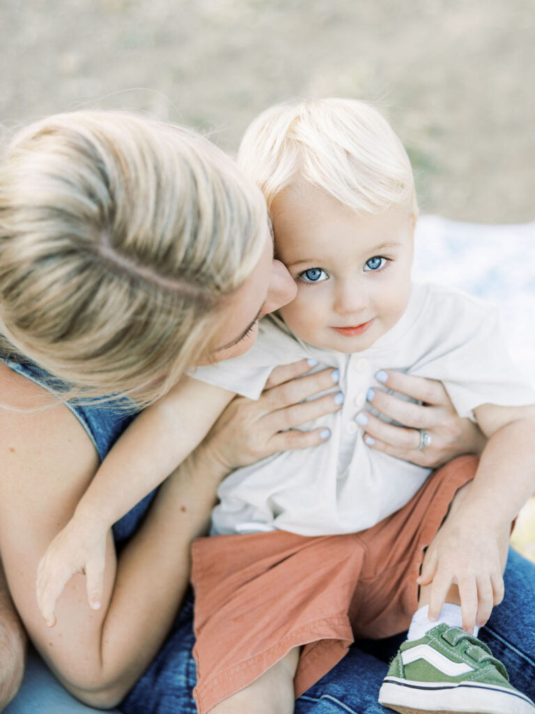 Mom leaning in close to her toddler during a relaxed Santa Clarita family photo session with young children.