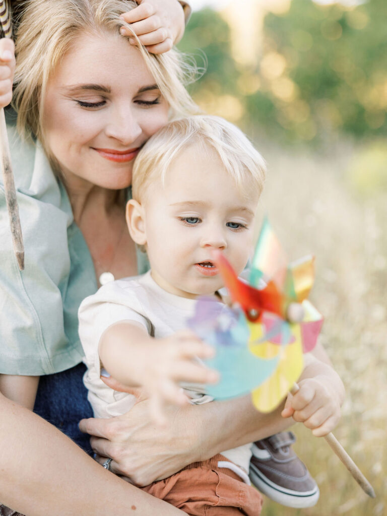Mom holding her toddler close during a candid Santa Clarita family photography session