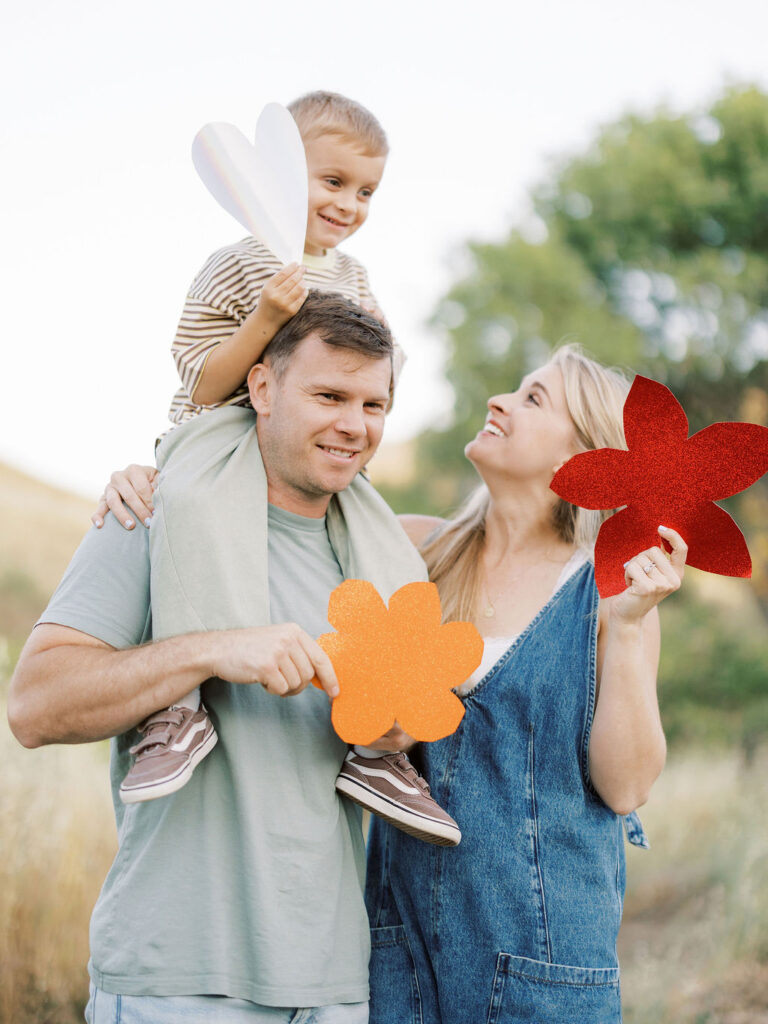 Dad lifting his toddler into the air during a playful family photography session