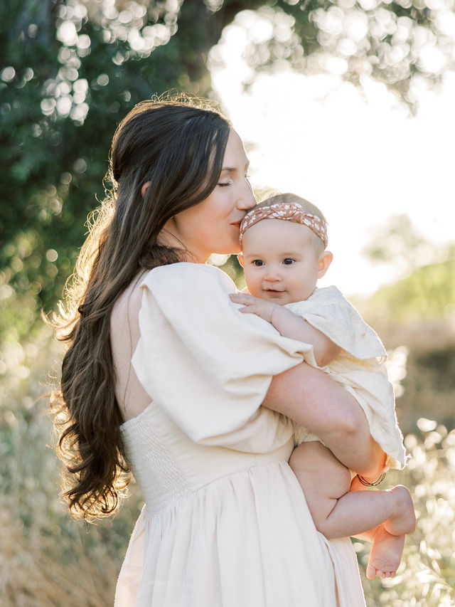 Mom kissing her baby during a natural family photo session in Santa Clarita