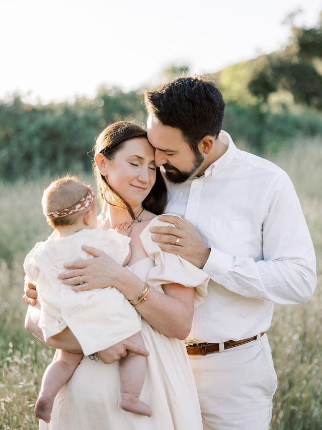 Parents cuddling their baby during natural family photos in Santa Clarita