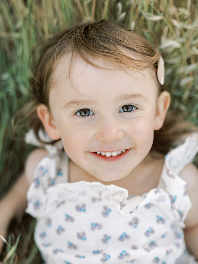 Smiling young girl during a natural family photography session outdoors