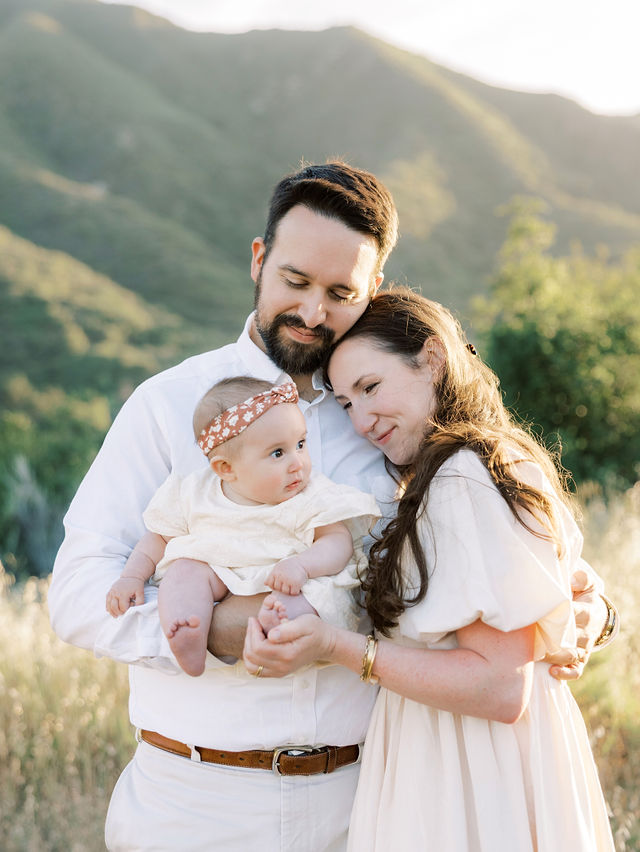 Parents cuddling their baby during a relaxed outdoor family photo session in Placerita Canyon, CA