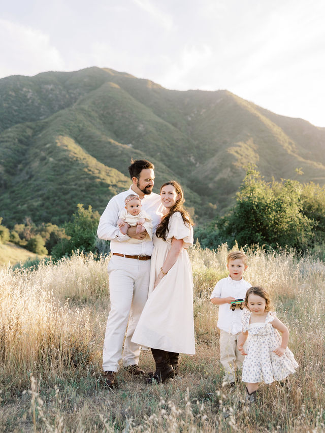 Family of five enjoying natural family photos together in the golden evening light