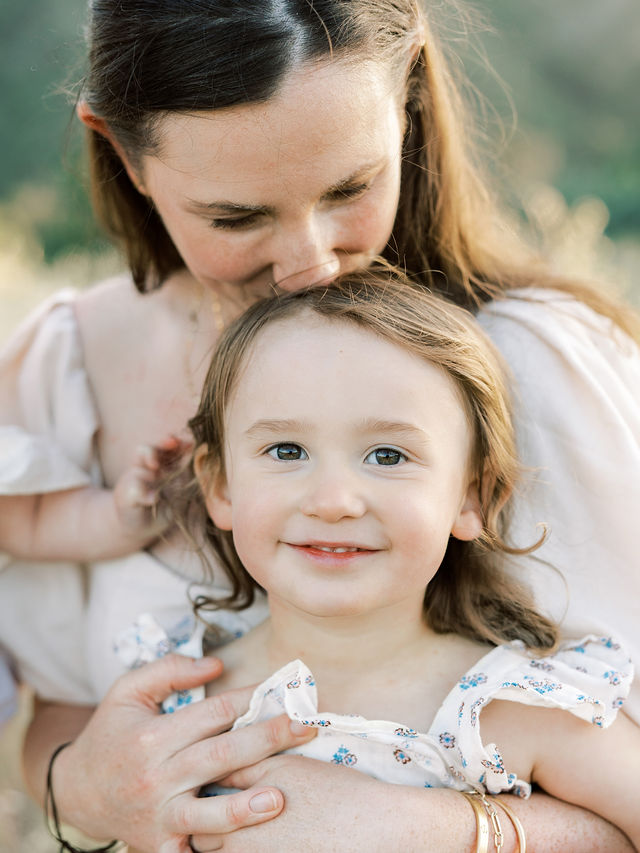 Mom cuddling her daughter for natural family photos with kids in Santa Clarita, CA