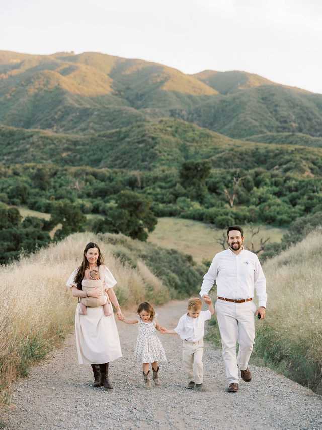 Family of five walking together during an outdoor family photo session in Santa Clarita