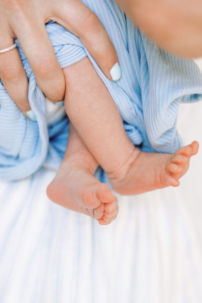 Close-up of a newborn’s tiny hand and fingers during a lifestyle newborn session.