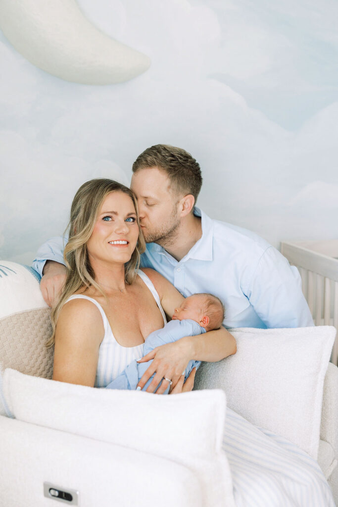New parents cuddling close with their baby in their Santa Clarita home.