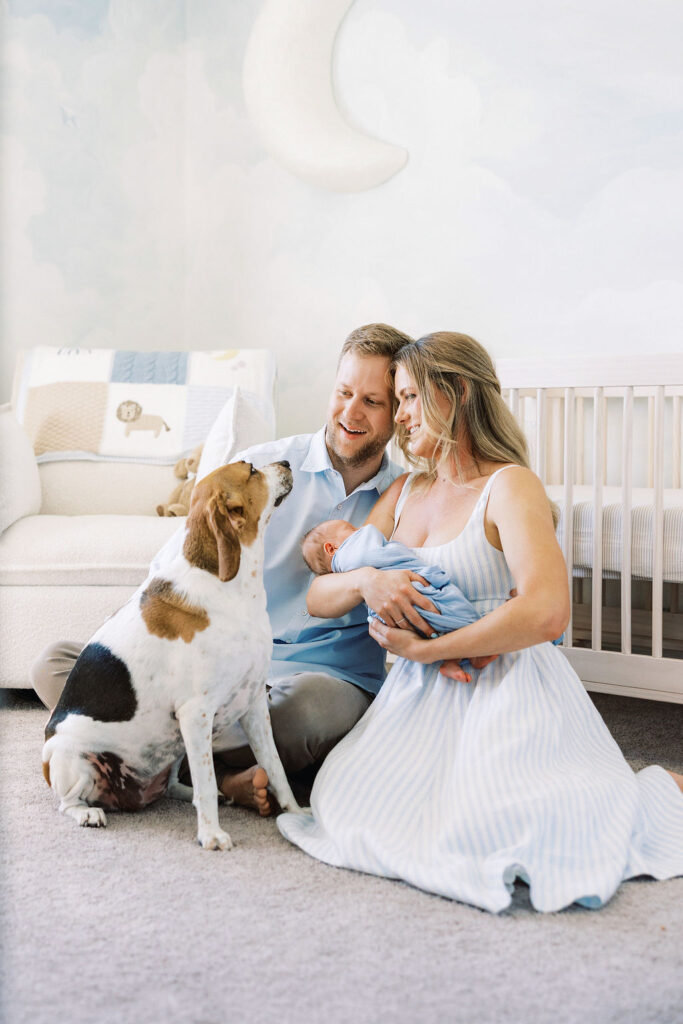 Mom holding her newborn beside the crib during a Santa Clarita lifestyle newborn session.