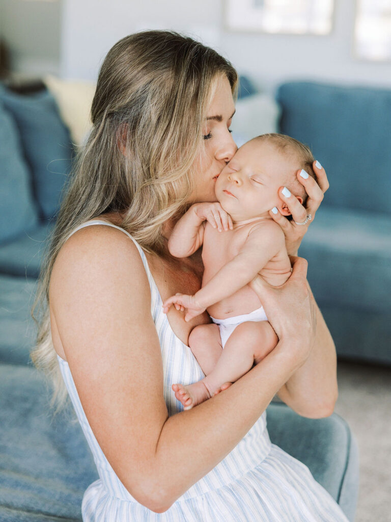 Mom kissing her newborn’s cheek during a Santa Clarita newborn photography session.