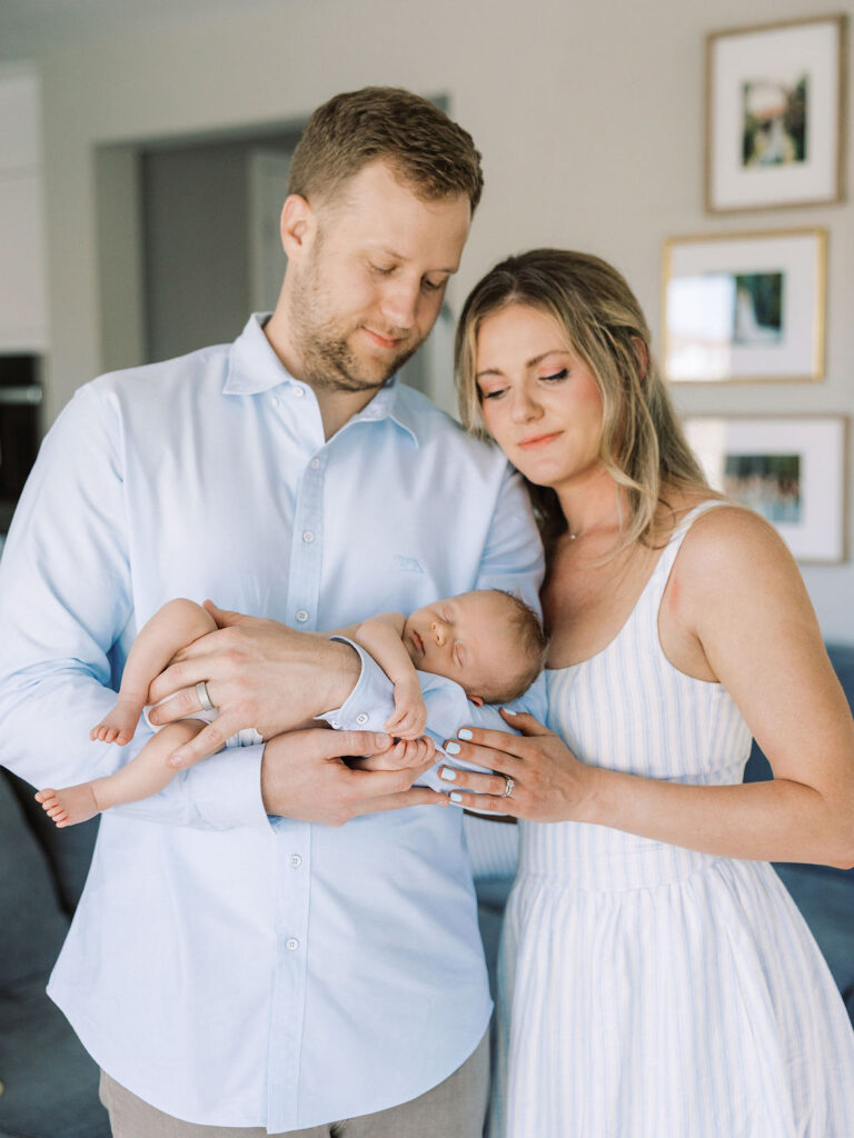 New parents holding their baby together inside their Santa Clarita home.