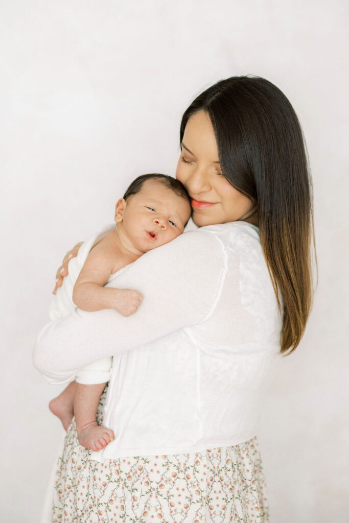 Mom holding her baby close during a lifestyle newborn photography session