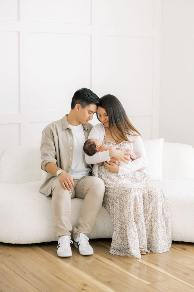 Mom and dad cuddling there newborn baby during a relaxed Santa Clarita newborn session
