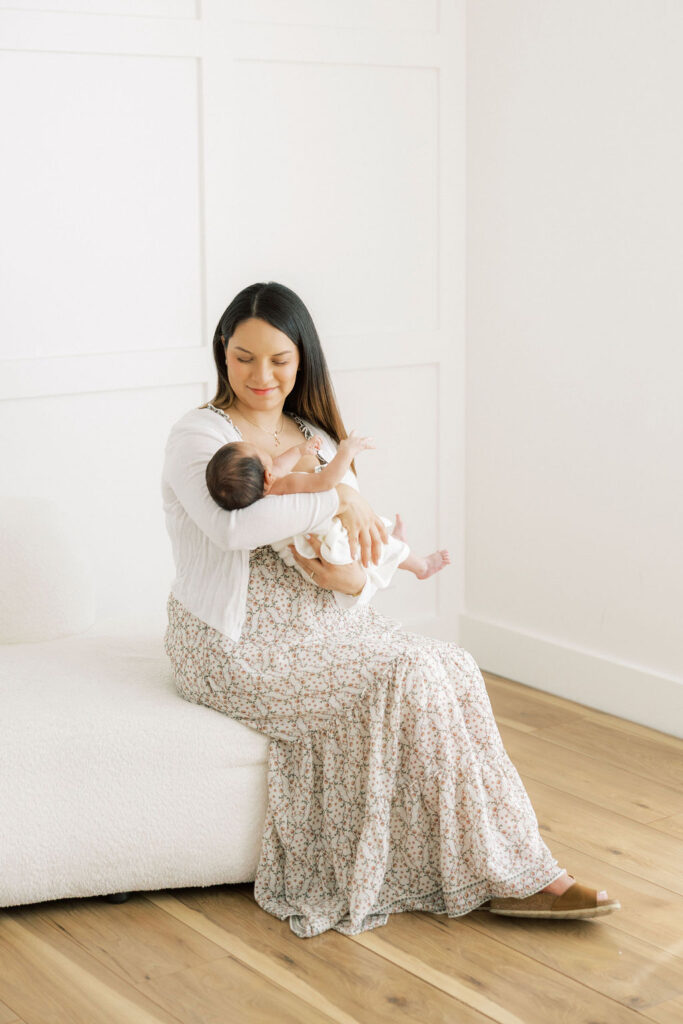Mom looking lovingly at her newborn baby during a studio newborn session