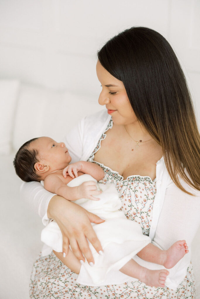 Mother holding her baby during a lifestyle newborn photography session