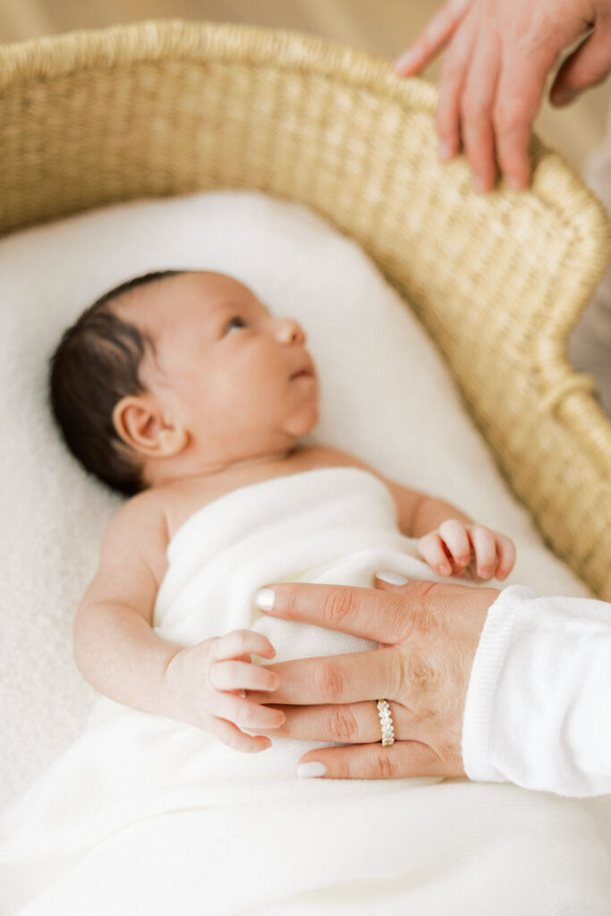 Sleeping newborn baby wrapped in a soft blanket during a studio session