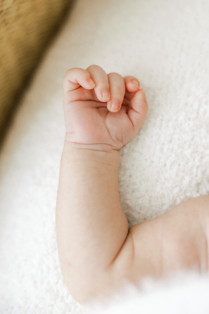 Close up of a newborn baby’s tiny hand during a lifestyle newborn session