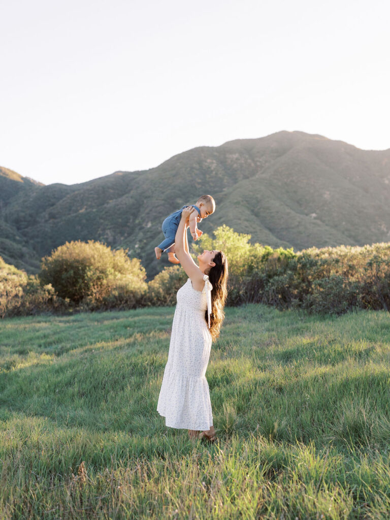 Mom holding her child up in the air child during a Santa Clarita family photo session