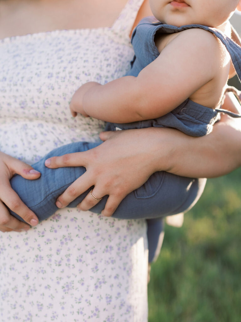 Close up of mom holding her child during an outdoor family photo session
