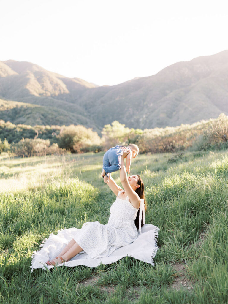 Mom and baby smiling together during natural family photos with kids
