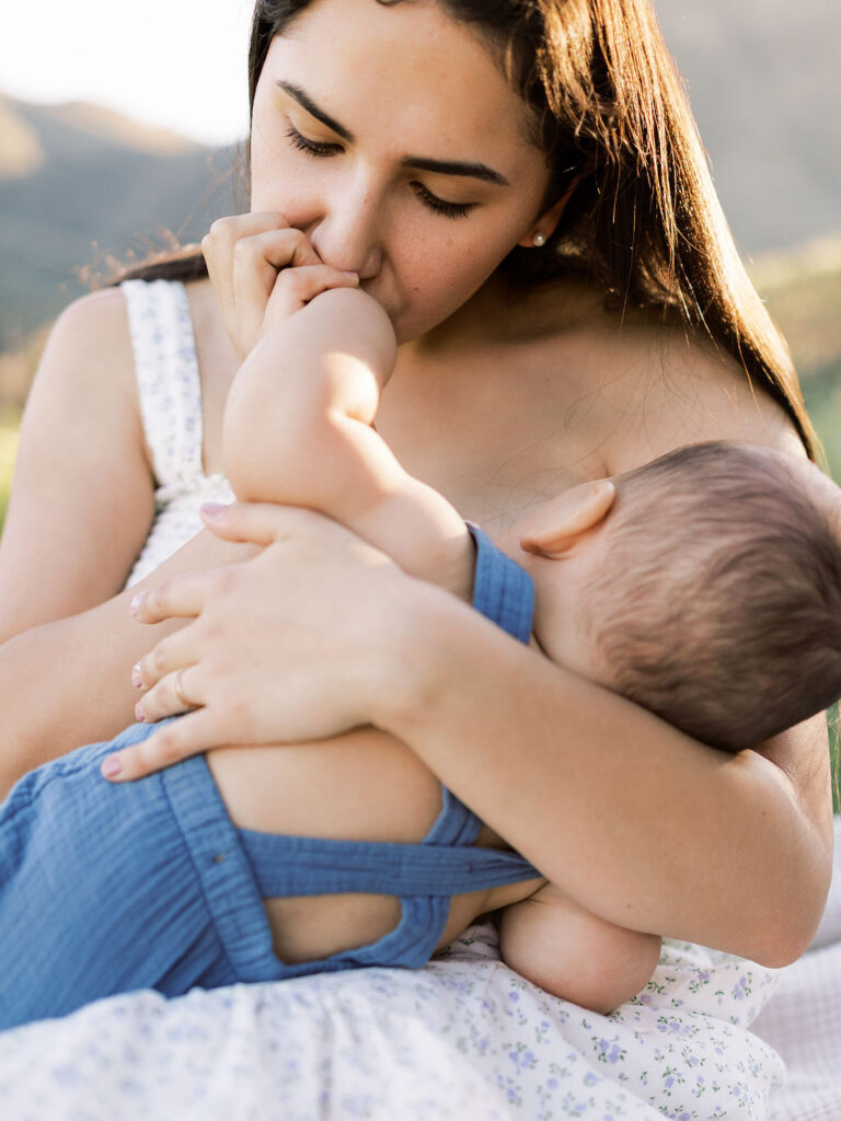 Mom kissing her baby during a candid family photography session