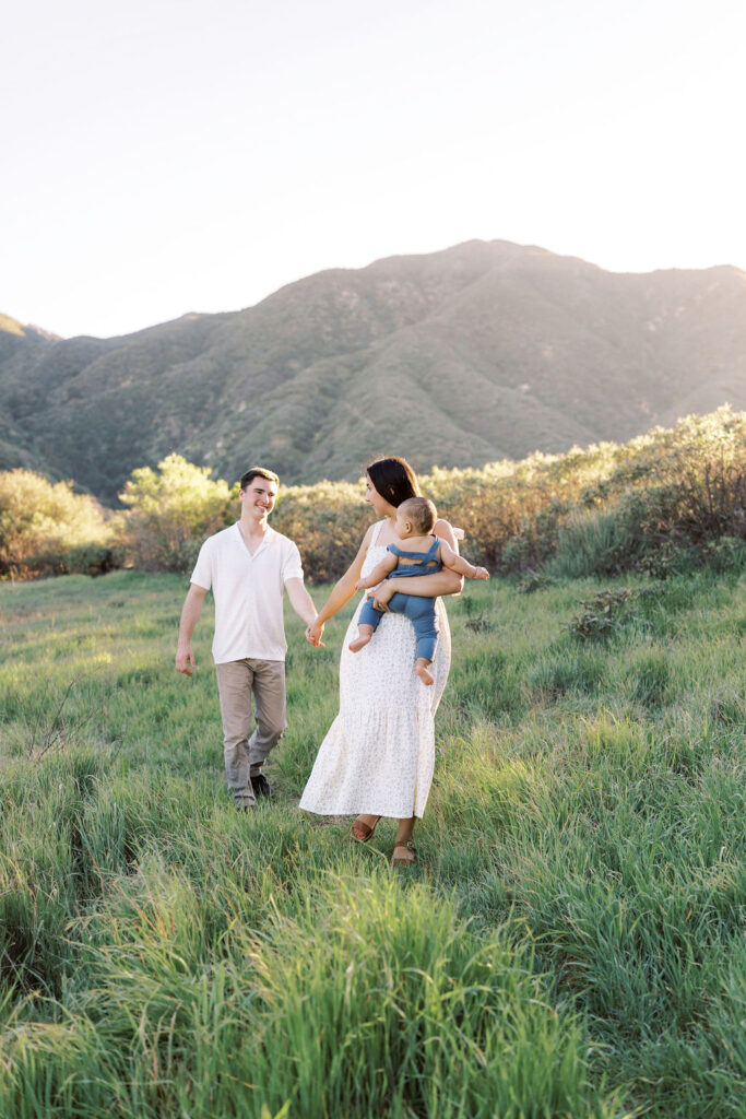 Parents walking hand in hand with their child in the Santa Clarita hills