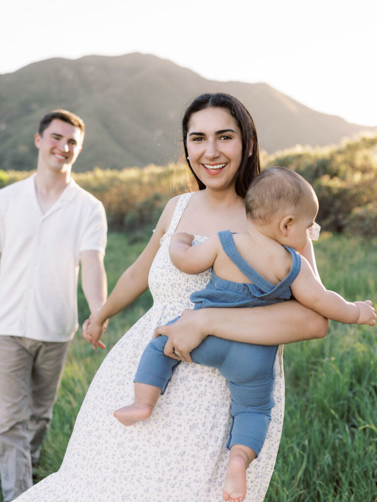 Mom and dad cuddling their baby during a natural family photo session in Santa Clarita