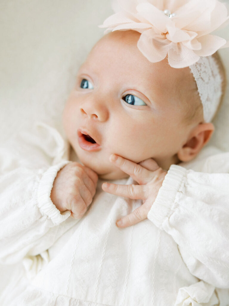 Close up of a newborn baby’s tiny feet resting in a parent’s hands during a lifestyle newborn session.
