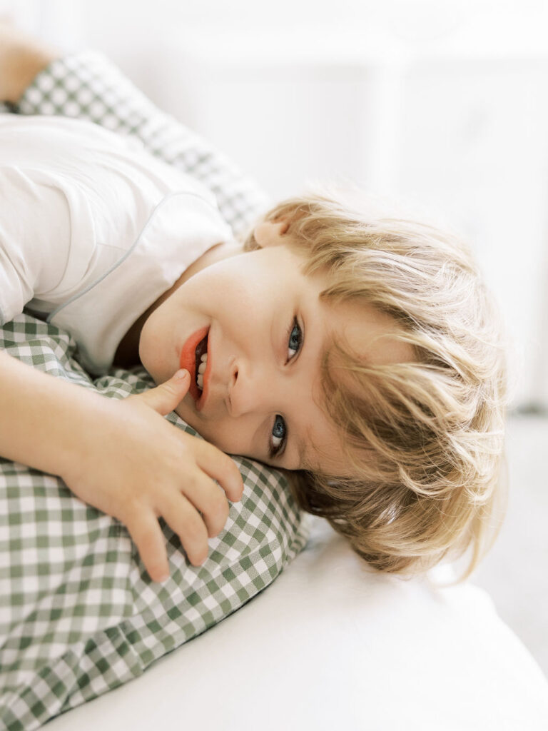 Older sibling resting beside the newborn during a natural sibling photography moment