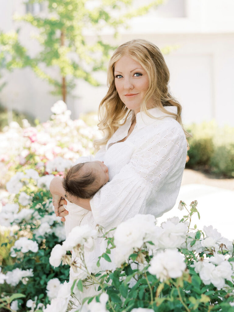 Mother cuddling her newborn baby in soft natural light