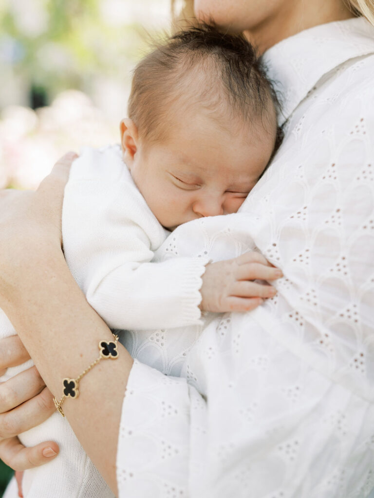 Newborn baby resting against mom during a relaxed newborn photography session