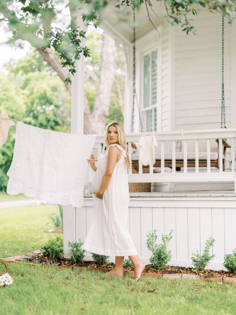 Pregnant woman outdoors in a flowing dress while preparing for maternity photos in Santa Clarita