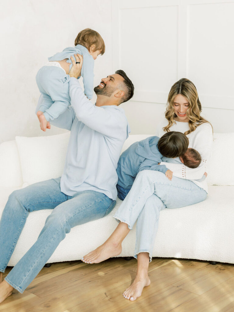 Family enjoying a natural moment together during a Santa Clarita studio newborn photography session