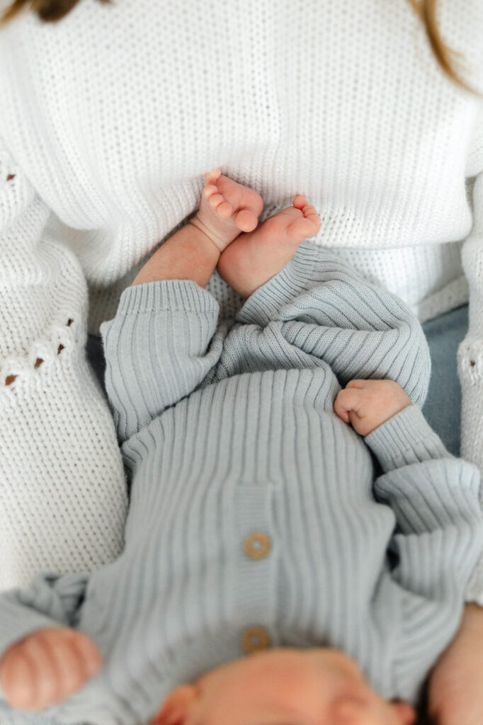 Close up of a newborn baby’s tiny feet and hands during a natural studio session