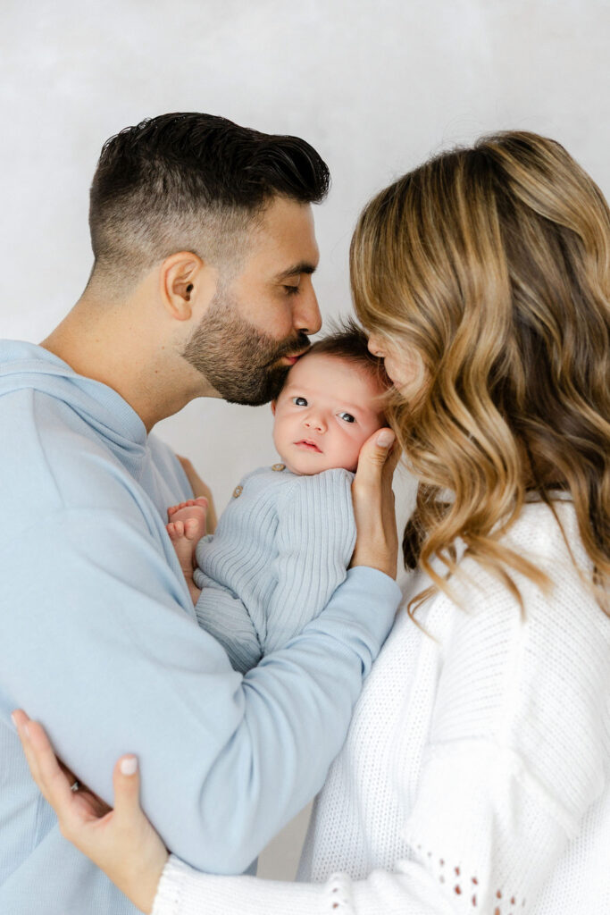 Mom and dad sharing a sweet moment with their newborn baby