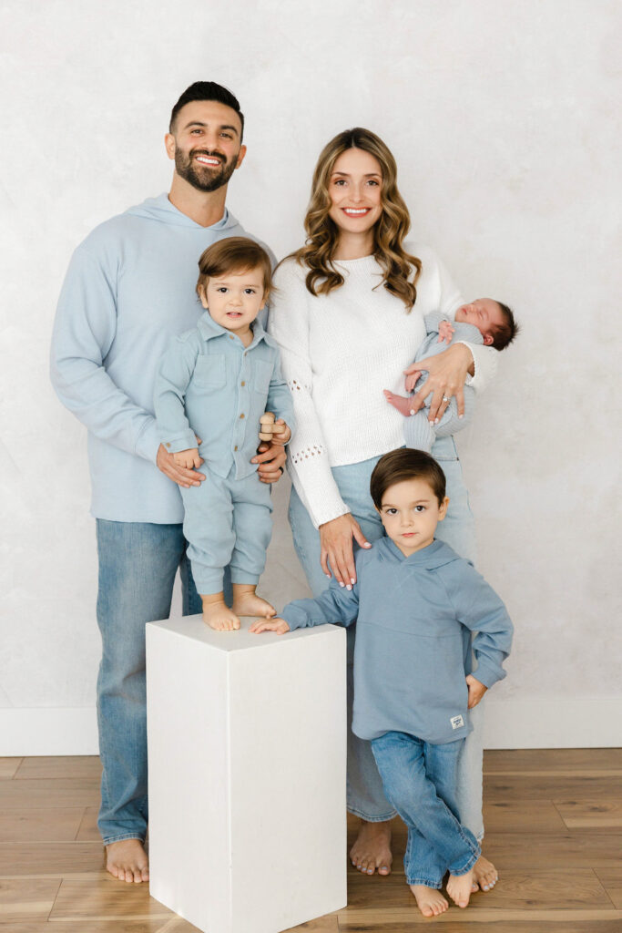 Family of five together during a studio newborn photography session