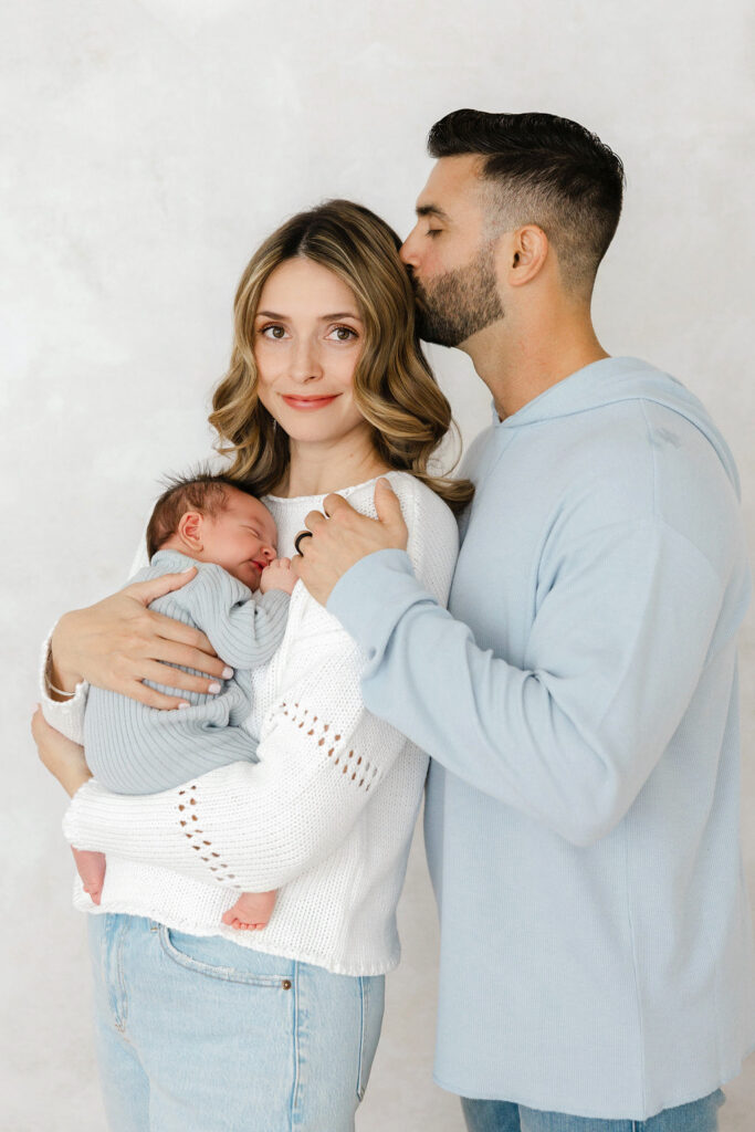 Mother holding her newborn baby close during a natural family moment