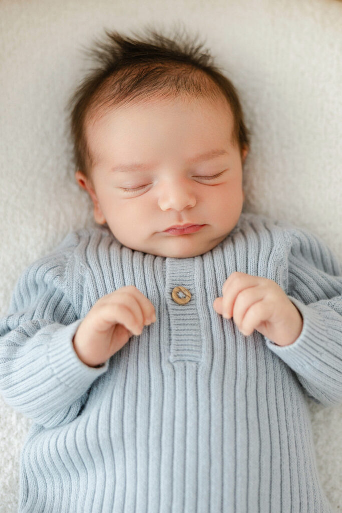 Sleeping newborn baby photographed in soft natural light