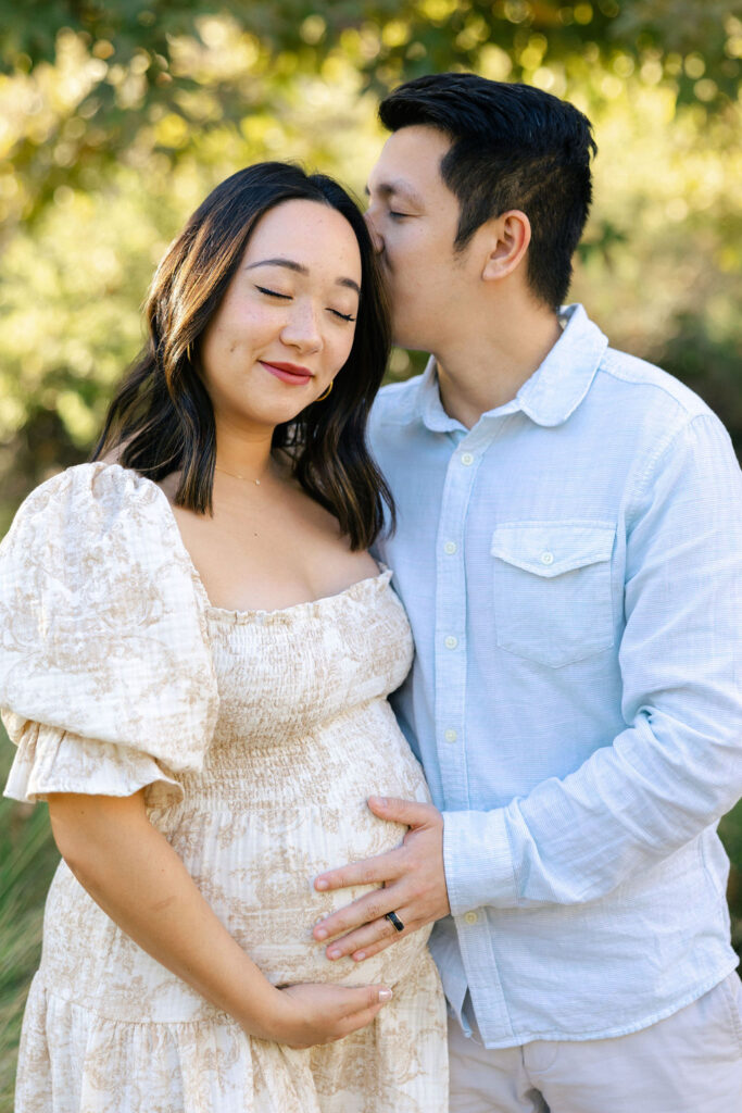 Pregnant mom walking through a natural setting in a flowing dress for her maternity photo session