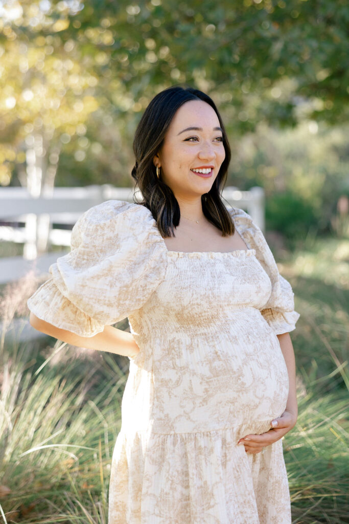 Expecting mom wearing a soft floral maternity photo outfit with feminine puff sleeves