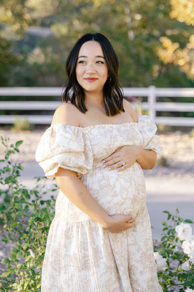Pregnant mom wearing a romantic floral dress during a Santa Clarita maternity photography session