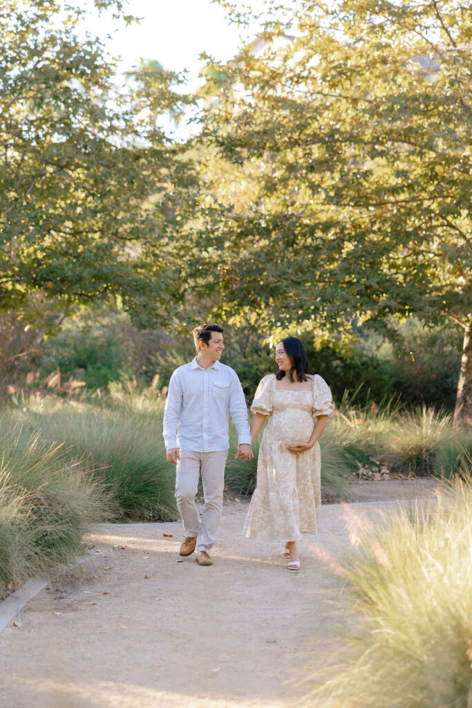 Expecting couple walking together outdoors during a natural Santa Clarita maternity photography session