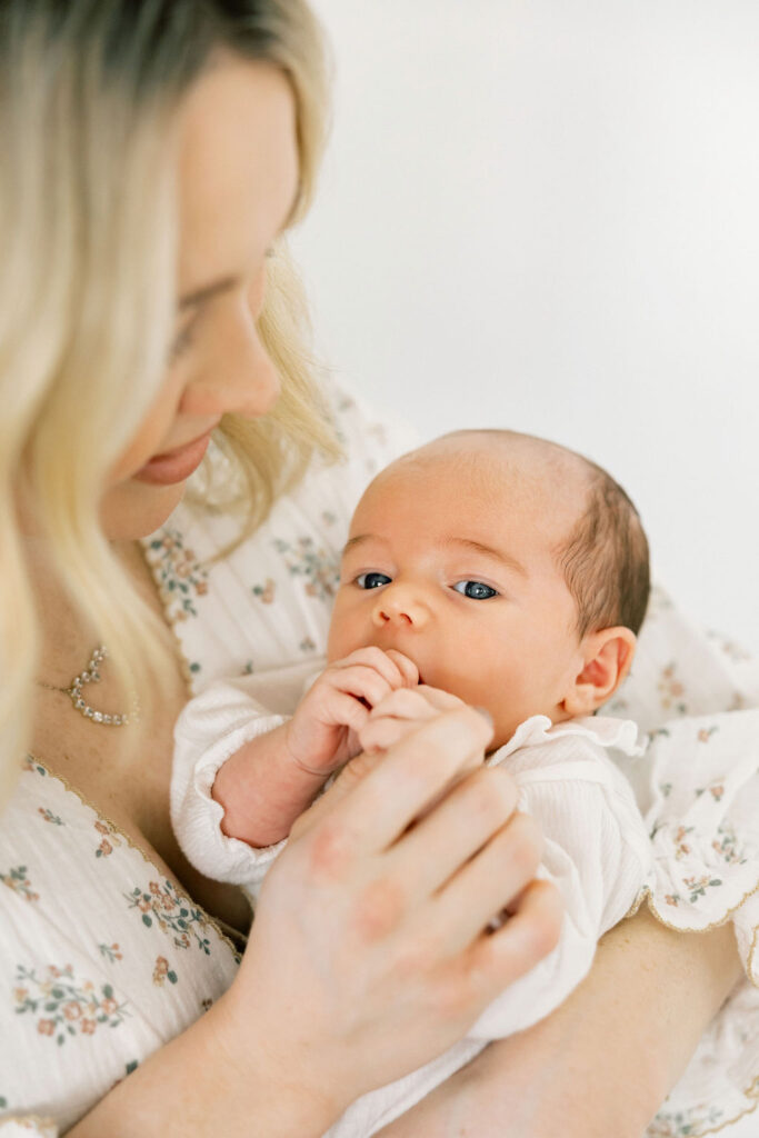 Mother looking down at her baby during an in home newborn photo session
