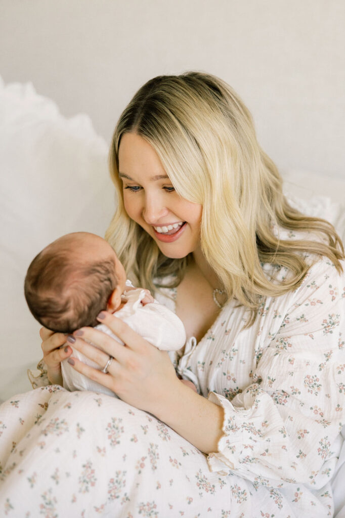 Mother cuddling her newborn close during natural newborn photography