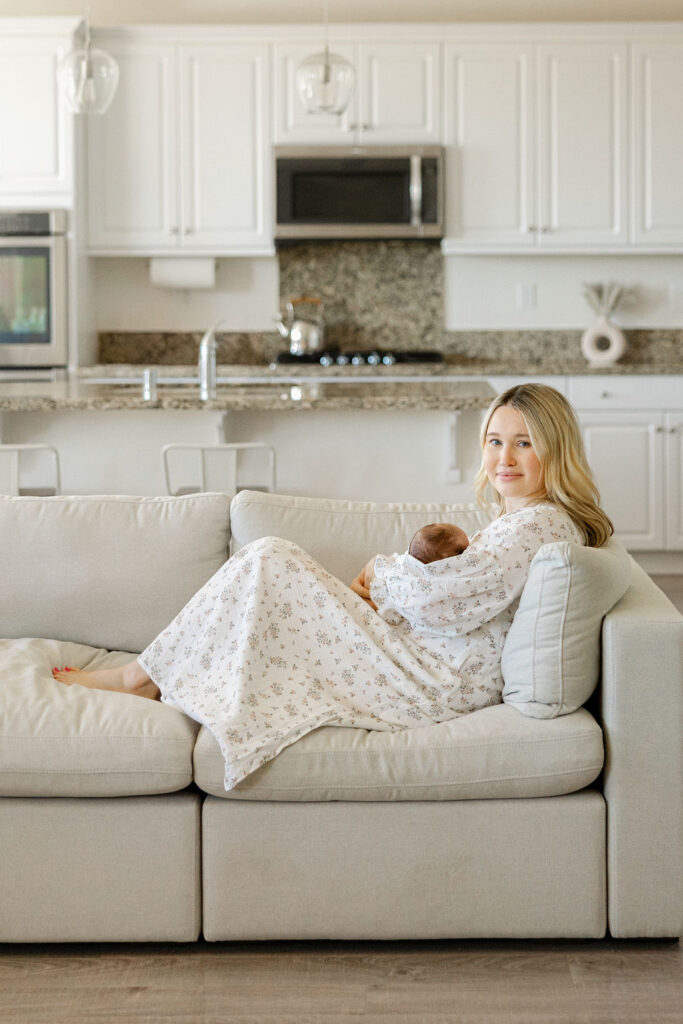 Mother and newborn relaxing together during an in home newborn photo session