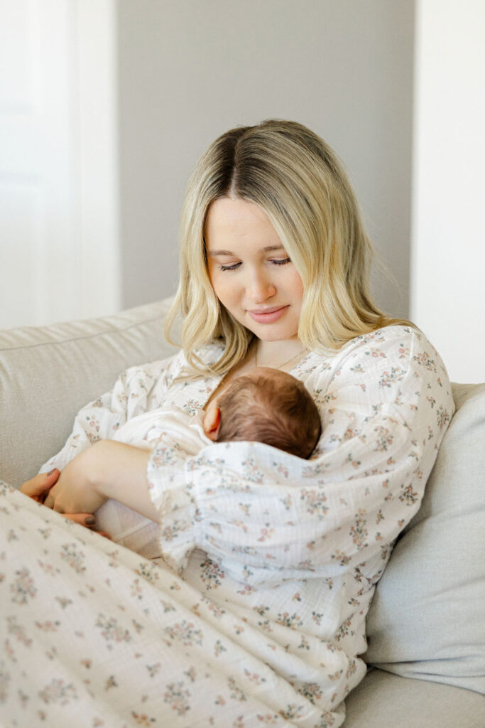 Mother cuddling her baby during a lifestyle newborn photography session