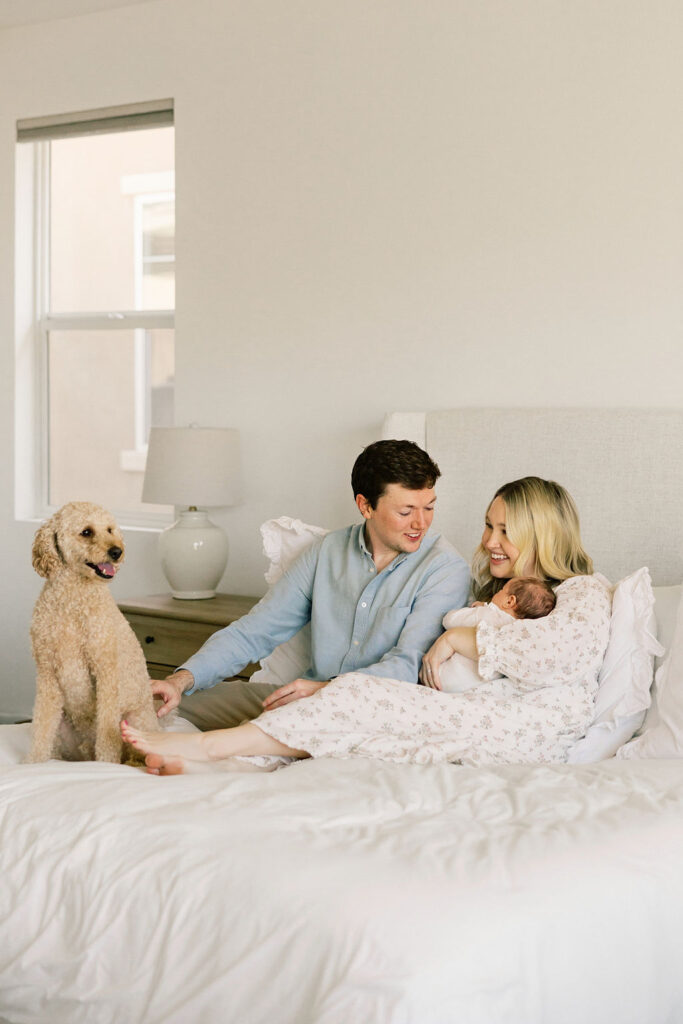 Parents cuddling their newborn during a relaxed Santa Clarita newborn photography session