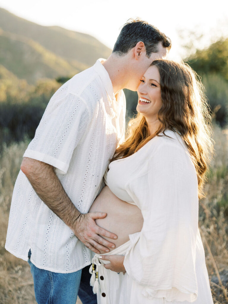 Pregnant woman smiling during her Santa Clarita maternity portrait session