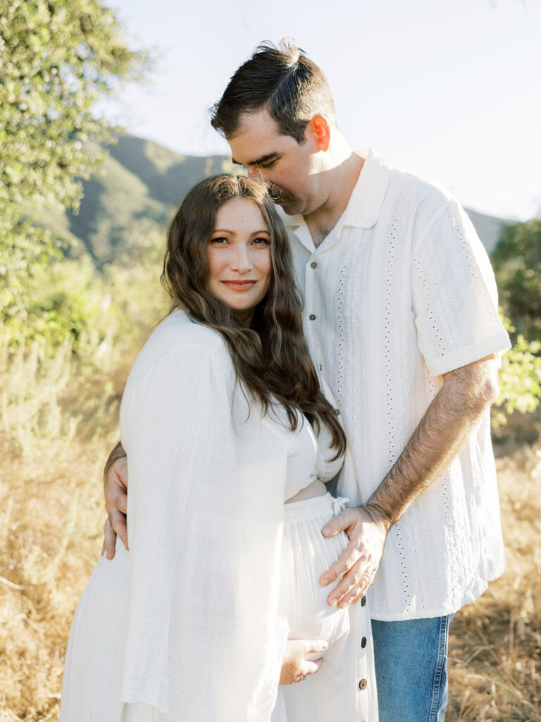 Expecting couple embracing outdoors during a Santa Clarita maternity photography session